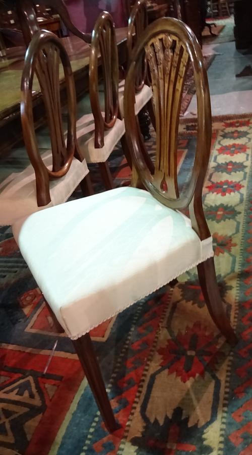 A set of six George III style oval back mahogany dining chairs, on tapering square supports, (6).  1026 E6