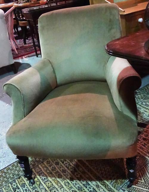 A Victorian easy armchair on turned ebonised supports, 70cm wide.  1115