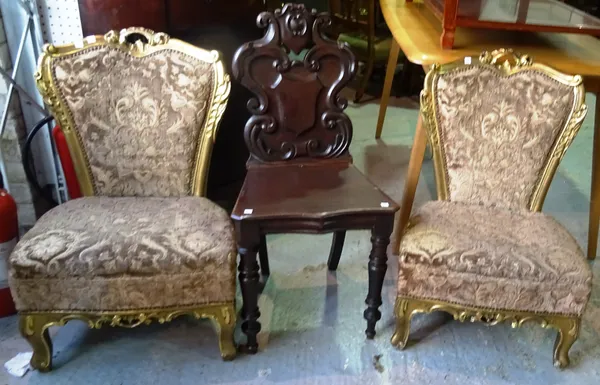A pair of Victorian gilt framed nursing chairs and a mahogany hall chair, (3).  D8