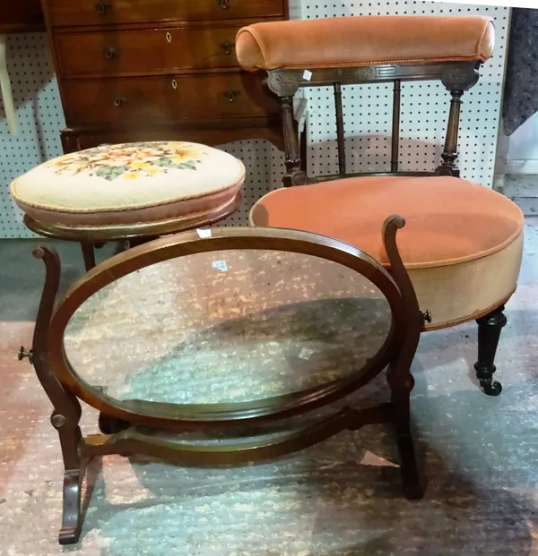 A Victorian low nursing chair on turned ebonised supports, a Victorian mahogany adjustable piano stool and a mahogany oval toilet mirror, (3).  C5