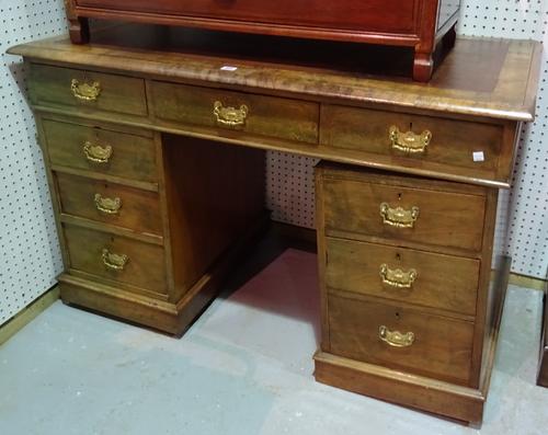 An early 20th century walnut pedestal desk with brown leather inset top, 122cm wide x 78cm high.  B9