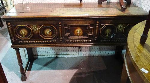 A 17th style century oak dresser base, the three drawers with geometric moulding, 135cm wide x 82cm high.  B6