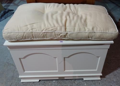 A 20th century white painted lift top trunk with a small quantity of 20th century toys, 92cm wide x 56cm high.  K5