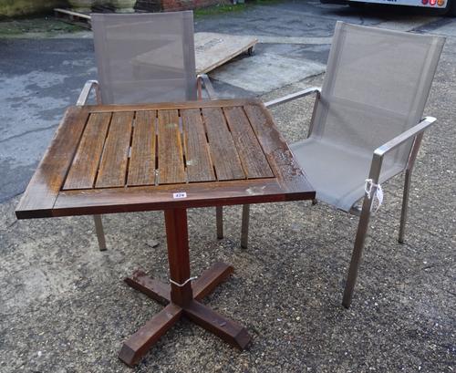 'Indian Ocean Trading Company'; A hardwood square garden table, 71cm wide x 71cm high, with two metal and hardwood open armchairs, (3).  OUT