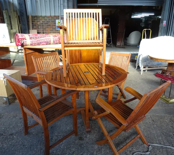 'Indian Ocean Trading Company'; A 20th century hardwood circular garden table with three armchairs and a pair of hardwood folding garden chairs. (6)