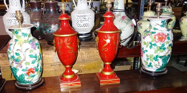 A pair of 20th century Asian style porcelain table lamps decorated with birds and flowers (56cm) and a pair of red painted metal urn shaped lamps and