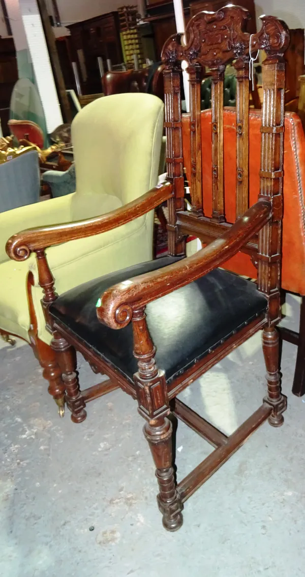 A Victorian oak open armchair, with carved top rail, on turned supports.  H3