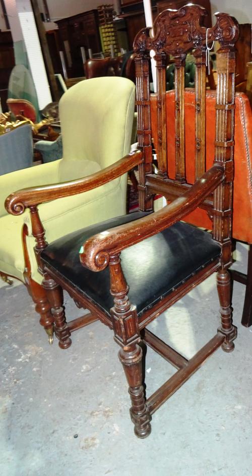 A Victorian oak open armchair, with carved top rail, on turned supports.  H3