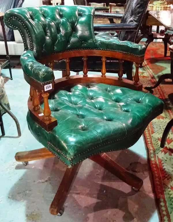 A Victorian style mahogany captain's swivel desk chair, with green leather button back upholstery.  E5