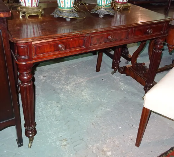 A William IV style mahogany side table, on flared fluted supports, 114cm wide x 56cm high.  E6