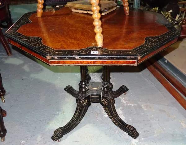 A late Victorian burr walnut and ebonised octagonal occasional table, with four turned columns, on outswept supports, 92cm wide x 72cm high.  F2