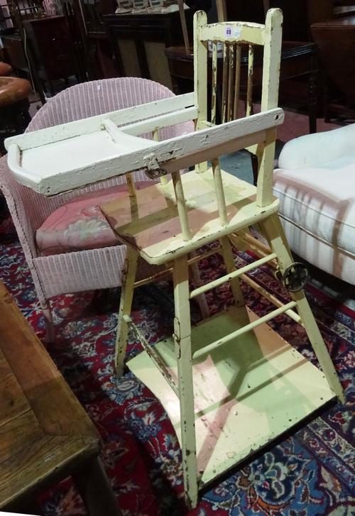An early 20th century yellow painted child's high chair.  J5