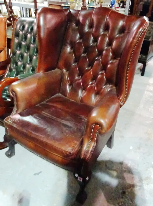 A 18th century style mahogany framed leather wingback armchair on ball and claw feet.  H4