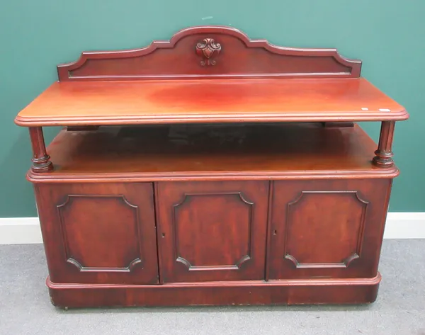 A Victorian mahogany buffet, with open tier over three panel cupboards, on plinth base, 138cm wide x 108cm high x 53cm deep.  G6