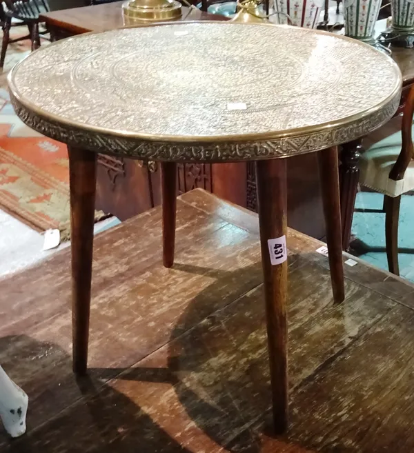 An early 20th century Indian circular brass table on tapering supports, 45cm wide x 41cm high.  G6