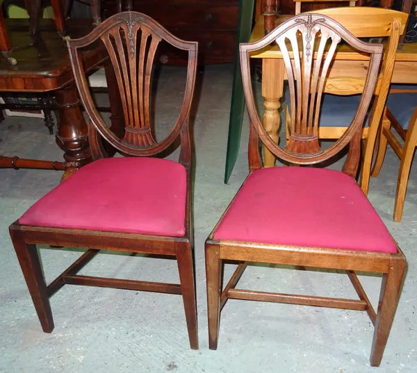A set of three Victorian mahogany shield back dining chairs on square tapering supports, (3). I7