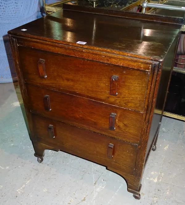 A 20th century oak bedside chest with two short drawers, 62cm wide x 74cm high, together with another similar, 60cm wide x 75cm high.  I8