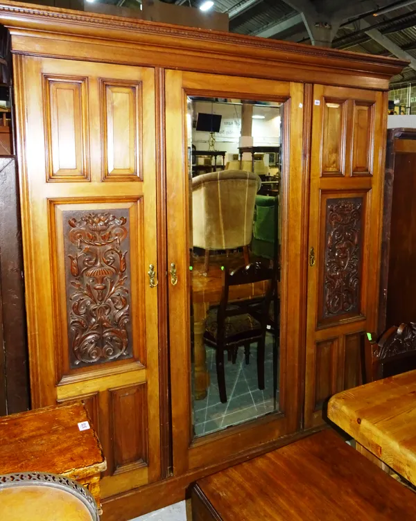 A Victorian walnut triple section wardrobe with inset carved panel door, 183cm wide x 205cm high.  K8