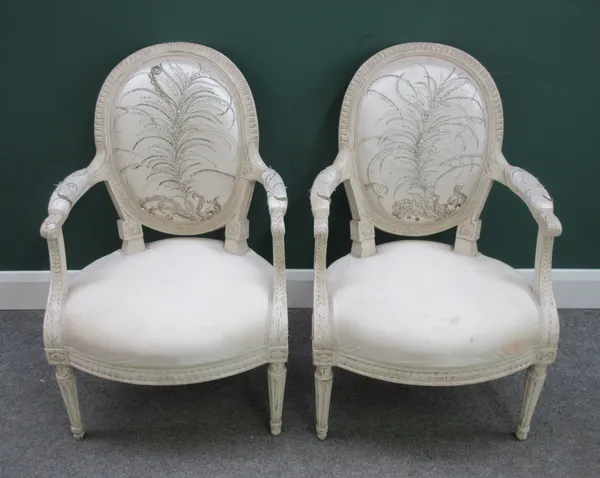A pair of white painted Louis XVI style armchairs with bow seats on tapering fluted supports, 58cm wide x 88cm high.  Dis