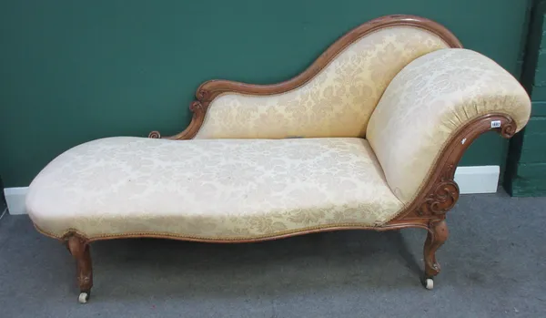 A Victorian carved mahogany scroll end chaise longue, on cabriole supports, 195cm wide x 91cm high.  M5
