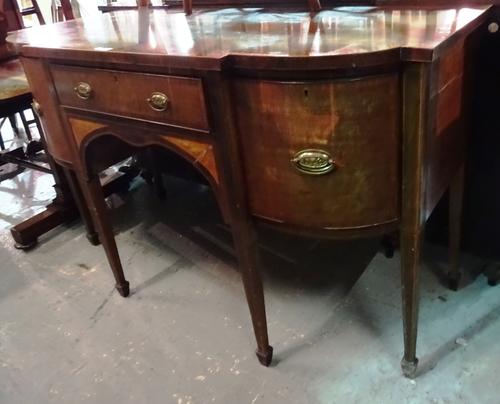 An early 19th century satinwood banded inlaid mahogany bowfront sideboard with central drawer flanked by further drawers and cupboard, on tapering squ