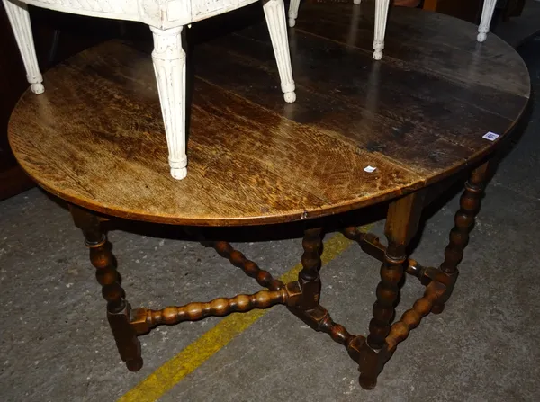 A 17th century style oak drop flap dining table on bobbin turned supports, 112cm wide x 76cm high.  Dis