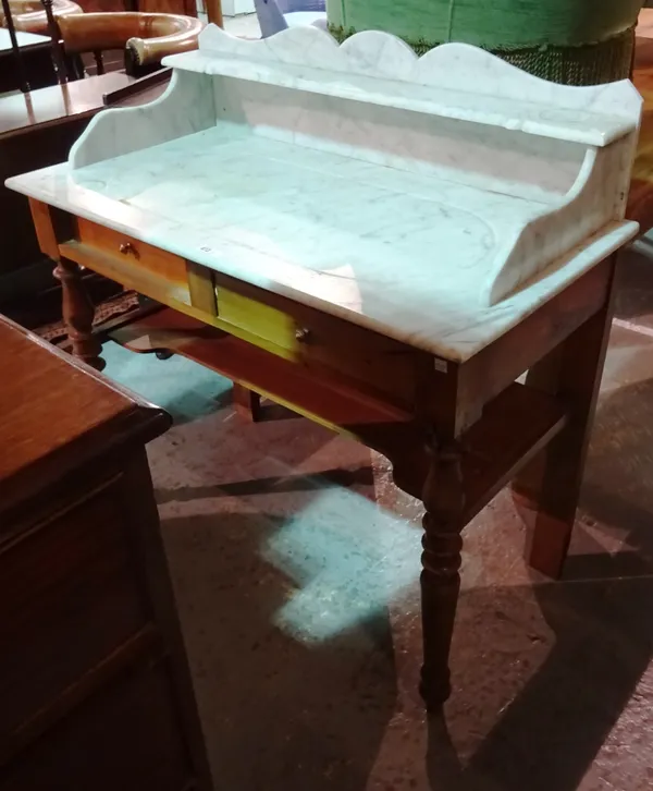 A 20th century pine washstand with a marble top and two short drawer base.  J7