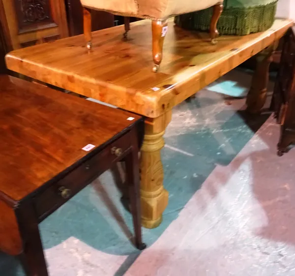 A 20th century pine kitchen table on turned supports, 180cm wide x 79cm long.  J8