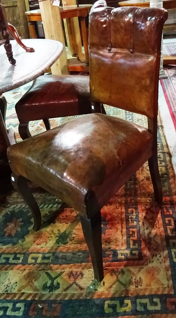 A set of four late 19th century French brown leather upholstered side chairs on stained oak cabriole supports. 49cm wide x 93cm high.  E7