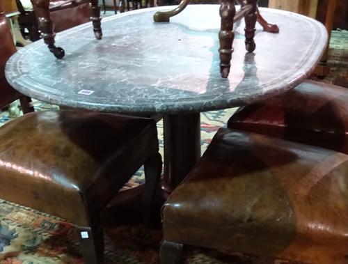 A marble topped centre table, the channelled oval top on an early 19th century French mahogany base with turned column and trefoil platform, 131cm wid