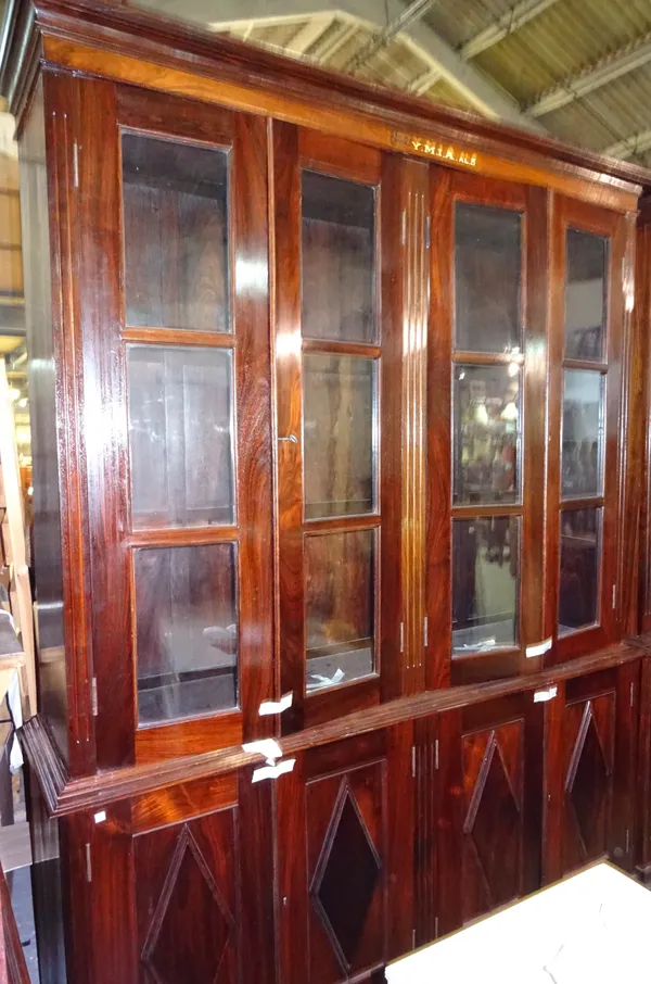 'YMIA MADRAS' An early 20th century Indian rosewood floor standing bookcase cupboard, 180cm wide x 243cm high.  Dis
