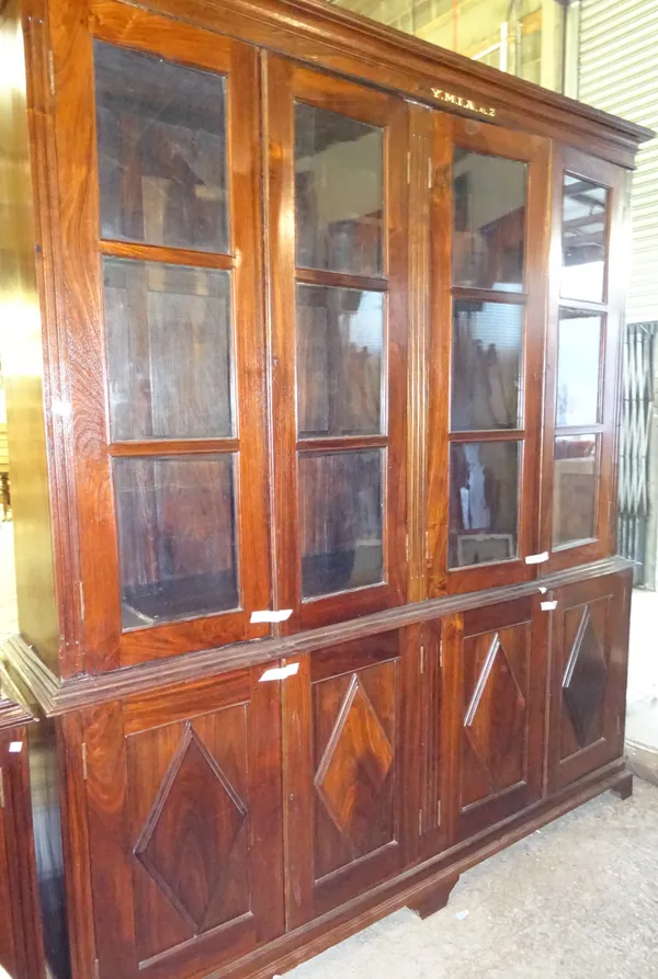 'YMIA MADRAS' An early 20th century Indian rosewood floor standing bookcase cupboard, 208cm wide x 243cm high.  Dis