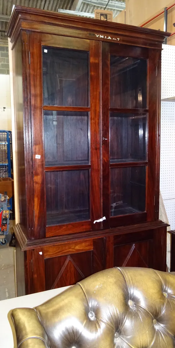 'YMIA MADRAS' An early 20th century Indian rosewood floor standing bookcase cupboard, 119cm wide x 243cm high.  Dis