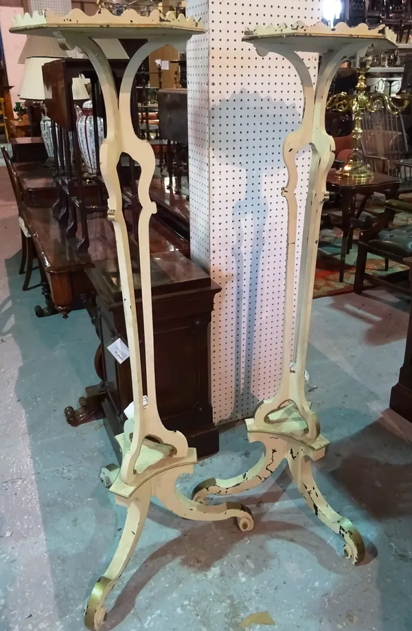 A pair of Continental cream painted torchère stands, each with hexagonal top over three pillar column, on scroll supports, 35cm wide x 145cm high, (2)