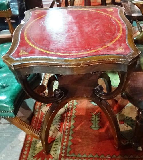 A pair of Regency style mahogany serpentine occasional tables, each with red leather inset top on four outswept supports, 54cm wide x 68cm high.  E5