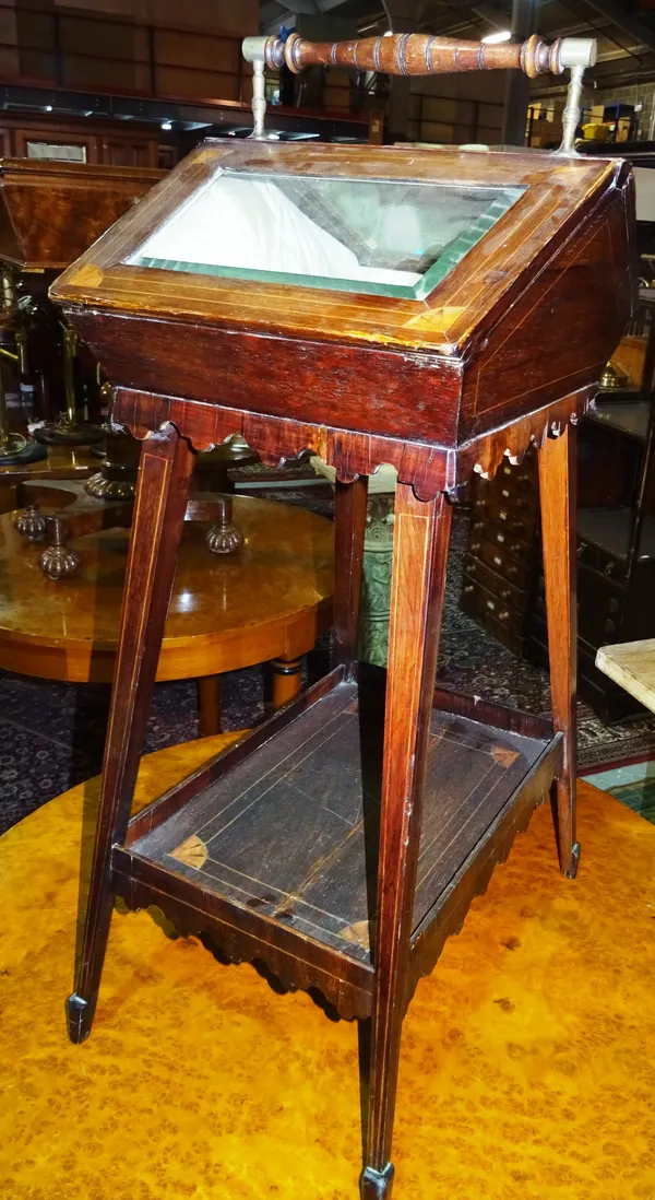 An Edwardian rosewood inlaid bijouterie table of sarcophagus form, on square tapering supports united by a platform undertier, 43cm wide x 80cm high.