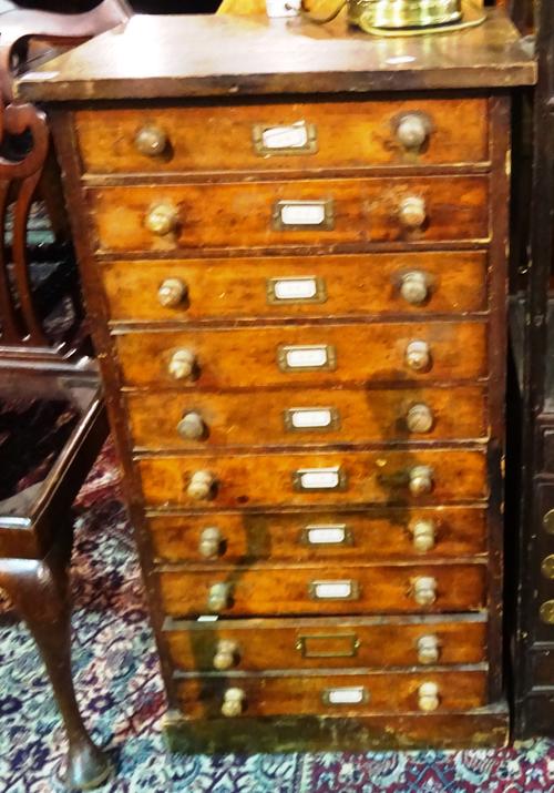 An early 20th century stained pine floor standing chest of ten drawers, with turned handles and plinth base, 52cm wide.  F7