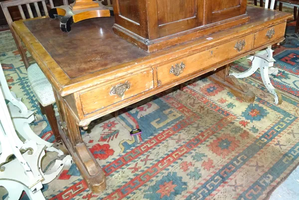 A late Victorian stained pine writing table, with three frieze drawers either side, on trestle end supports united by turned stretcher, 150cm wide x 7