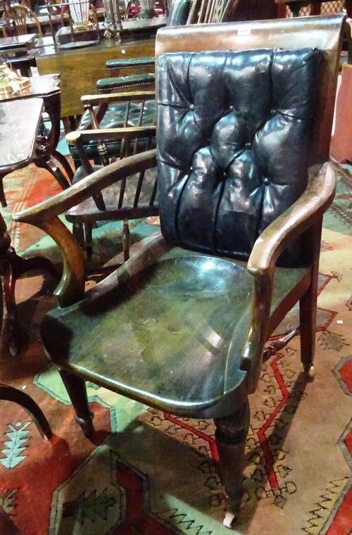 A Victorian elm desk chair with cushioned leather back, on turned supports.  E5