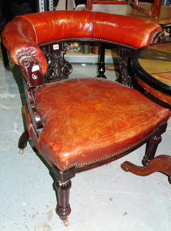 A Victorian mahogany framed tub back armchair, with carved uprights, on fluted tapering supports.  E4