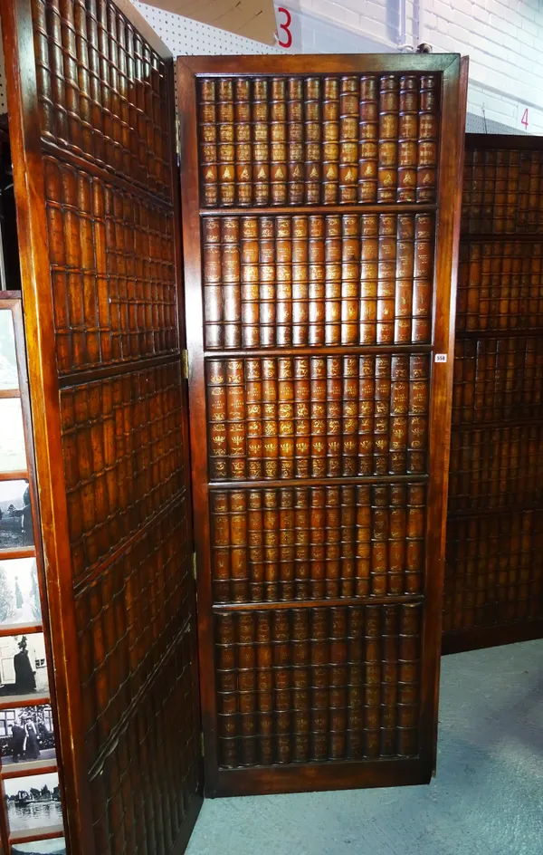 A pair of 20th century bi-fold hardwood screens, with faux book decoration, 71cm wide x 210cm high, (2).  C