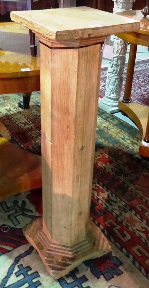 A pair of 20th century pine jardiniere stands, each with octagonal central column over a tiered octagonal base, 31cm wide x 100cm high.  E8