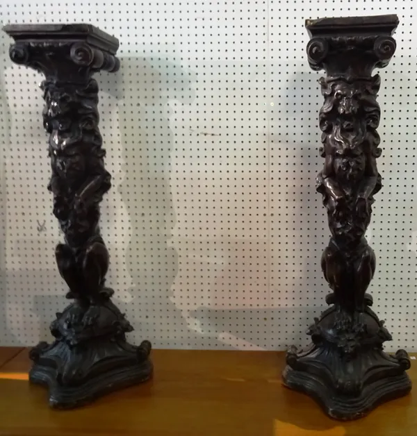 A pair of 20th century faux oak heraldic style jardiniere stands with carved lion central column on trefoil base, 23cm wide x 109cm high.  M9