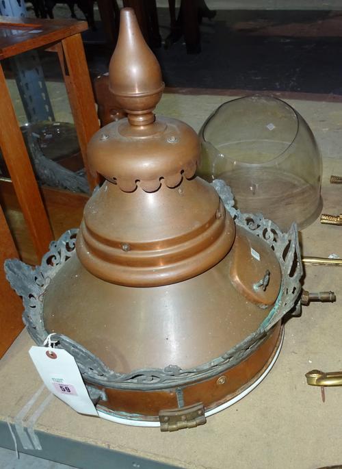 A late 19th century copper street lantern, with tapering spire and pierced castellated rim, over a domed clear glass shade, (a.f), 45cm diameter.  S2