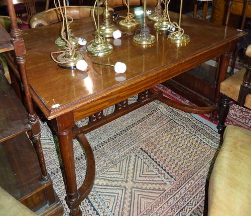 An Empire style mahogany rectangular centre table with turned tapering supports united by crinoline stretcher, 138cm wide x 78cm high  I7