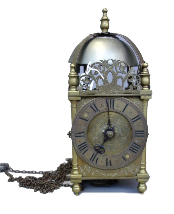 A brass lantern clock, the bell over a posted frame, the dial engraved with a Tudor rose, the movement with countwheel strike, 34cm high, (lead weight