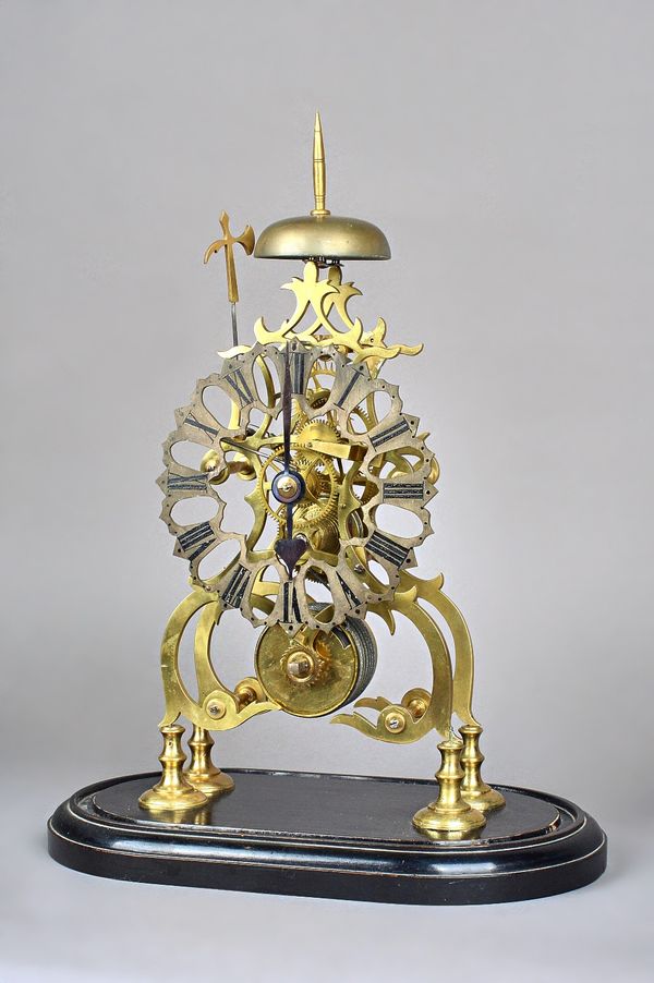 A Victorian style brass skeleton clock of typical open frame form, enclosing a single train fusée movement, housed under a glass dome, the clock 37cm