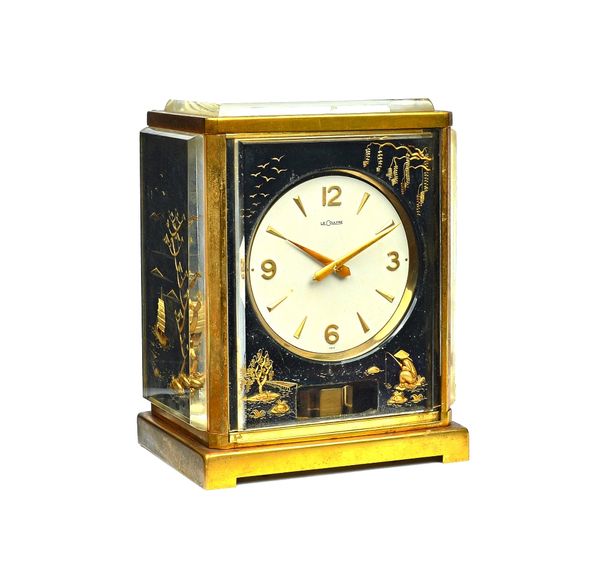A Jaeger Le Coultre 'Marina' Atmos clock, circa 1960, the perspex case gilt chinoiserie decorated with Chinese fishermen on rocks, with trees and boat