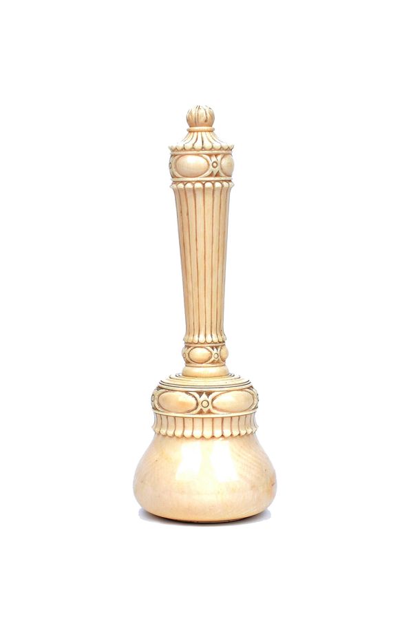 A Victorian ivory gavel, the ornately carved handle of fluted tapering form over a bulbous head inset with a hallmarked silver disc, 17cm long.  Illus