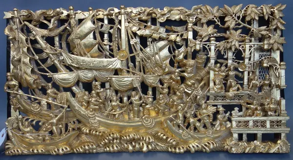 A Chinese giltwood wall panel, 20th century, ornately carved in relief with a ship departing harbour, paper trade label to the rear, 76cm x 38.5cm.